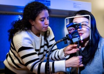 Audiologist Dr Elizabeth Rivera Rosario using the smartphone test to measure how a patient’s pupils involuntarily change size in response to sound. Image: Meredith Forrest Kulwicki, University at Buffalo.