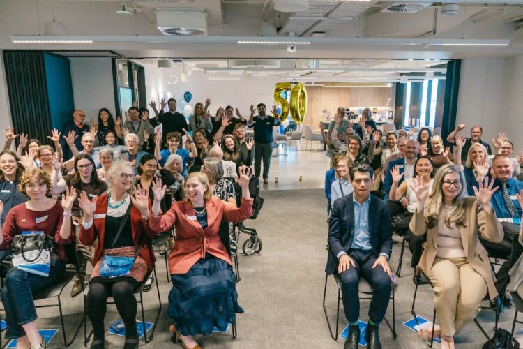 Guests clapping in Auslan at Expression Australia's golden anniversary celebration in Melbourne. Image: Expression Audiology.