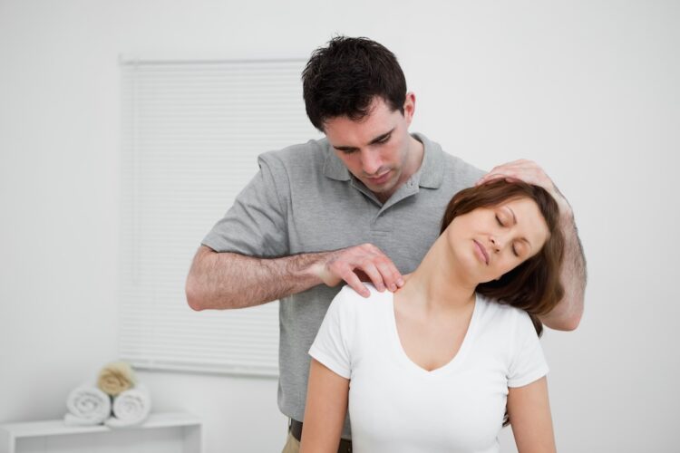 A physiotherapist palpating trigger points which can refer symptoms to the ear. Image: Wavebreakmedia/stock.adobe.com.