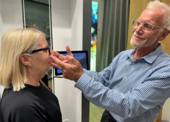 Queensland optometrist Michael Hare tries Nuance Audio Glasses on a patient. Image: Michael Hare.