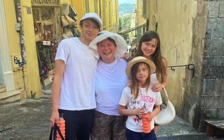 Linda Chee, whose hearing loss went unaddressed for several years, and her grandchildren. Image: Hearing Australia.
