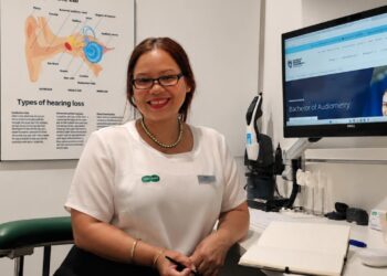 Brisbane audiometrist Nash October is studying her Bachelor of Audiometry online at Charles Darwin University. Image: Specsavers.