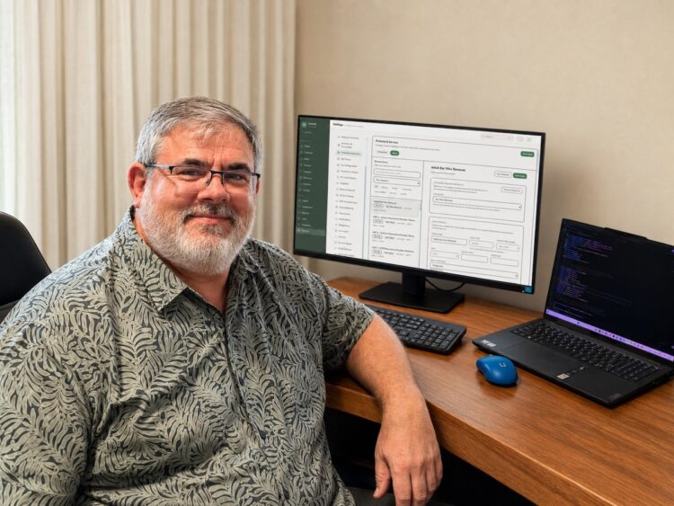 Gold Coast audiologist Christo Fourie working on the new AudZone Customer Relationship Management (CRM) system. Image: Christo Fourie.