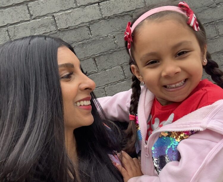 Melbourne audiologist Dr Verushka Selby-Hele and her daughter Santana wearing her bone conduction hearing aid on a softband. Image: Verushka Selby-Hele.