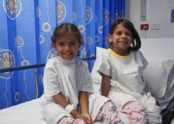 Twins Audrey and Dianne on the morning of their grommet surgery during the recent school holidays at The Royal Victorian Eye and Ear Hospital in Melbourne. Image: The Royal Victorian Eye and Ear Hospital.
